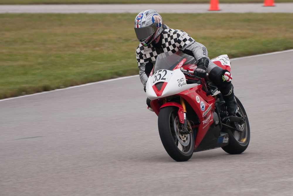 W W Bolton riding a 2007 Triumph, No 552 in the bend, Road America, Elkhart Lake, WI