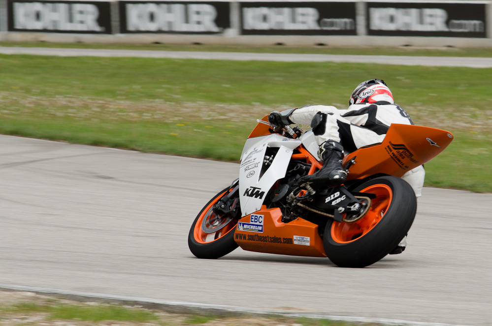 DSC_2131 / John Erdmann on the No 84 KTM in the bend at Road America, Elkhart Lake, WI